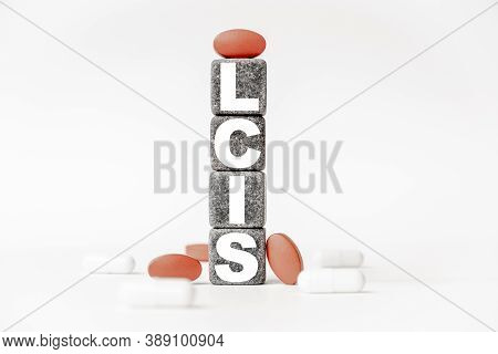 A Group Of White And Red Pills And Cubes With The Word Lcis Lobular Carcinoma In Situ On Them, White