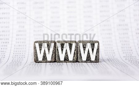 Three Stone Cubes On The Background Of White Financial Statements, Tables With The Word Www. World W