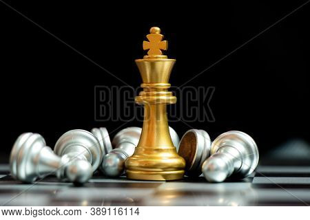 Gold King Chess Piece Win Over Lying Down Pawn On Black Background (concept For Leadership, Crisis M