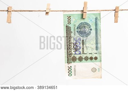 Uzbek Soums Hang On A Rope On A White Background. Money