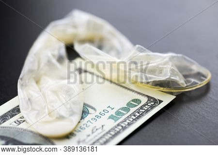 Used Condom And Us Dollars Bills. Cum In Condom. Prostitution Concept. Pay For Sex Per Night. Harlot
