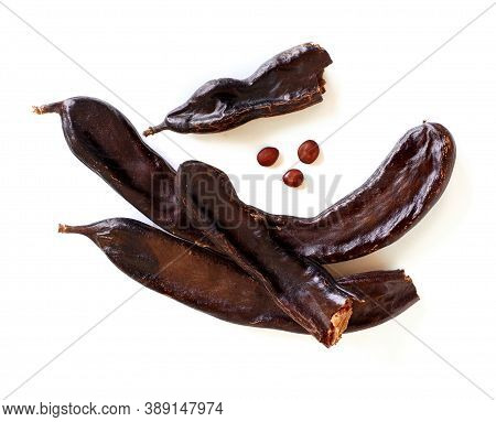 Dry Carob Pods And Seeds Top View Isolated On White