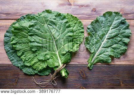 Leaves Of Rastan ( Collard Greens, Collards )  On Rustic Table. Flat Lay, Free Space For Text