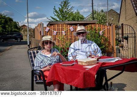 Ackworth, Uk - May 08, 2020: A Family Come Out From Houses To The Street To Celebrate 75th Anniversa