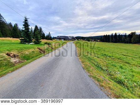 Country Road Near Kvilda Village Between Meadows In Sumava National Park With Beautiful Sunset Light