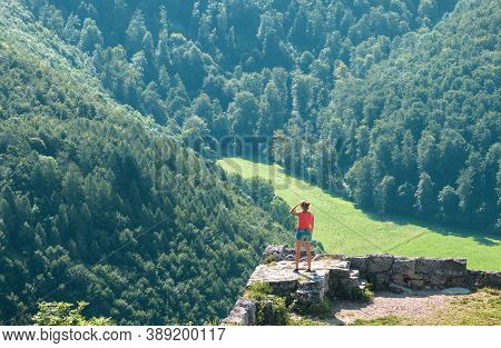 Landscape With Person And Old Ruins, Bad Urach, Germany. Female Traveler Standing On Remains Of Medi
