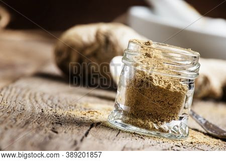 Ground Ginger In A Glass Jar And Fresh Ginger Root, Vintage Wooden Background, Selective Focus