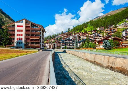 Traditional Local Houses Near The Matter Vispa River In The Centre Of Zermatt Town In The Valais Can