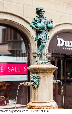 Luzern, Switzerland - July 12, 2019: The Little Goose Man Fountain At Hirschenplatz Main Square In L