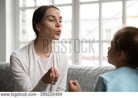 Caucasian Speech Therapist Teach Little Girl Pronunciation