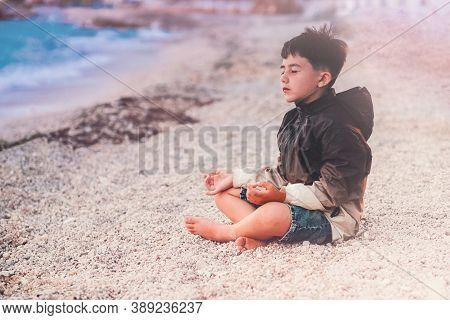 Little Boy Child Meditating On The Beach Mindful Breathing