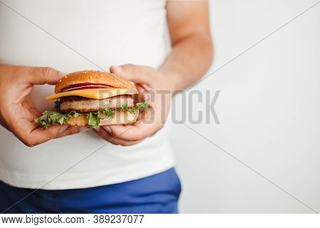Glutton Man Eating Tasty Burger. Imbalanced Ration, Unhealthy Eating, Snacking With Fast Food, Diet 