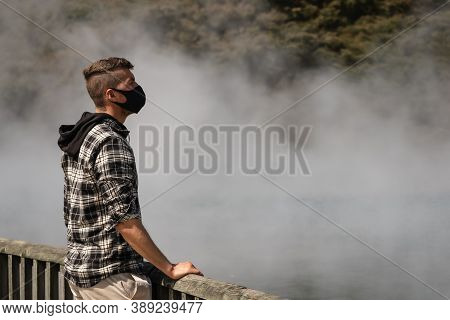 Caucasian Young Man Wearing Face Mask Visiting City With Hot Springs. Rotorua, New Zealand