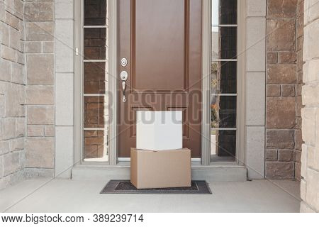 Contactless Delivery Service For Online Order. Cardboard Boxes Lying On Porch By Front Home Door. Co
