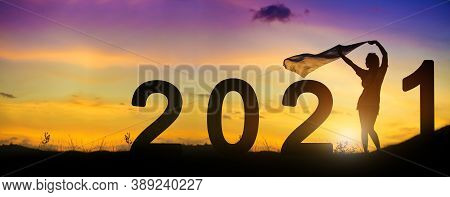 Silhouette Enjoying Women Flapping A Thin Fabric On The Hill While Celebrating 2021 Years In The Twi
