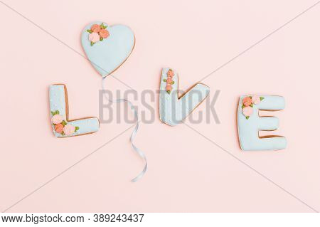 Gingerbread Heart, Cookies In Shape Of Letter Love With Icing On Pastel Pink Background. Valentines 