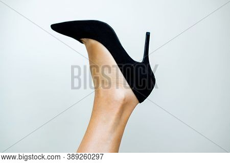 Perfect Part Of Beautiful Woman Feet In Black High Hell Sandals Against White Background