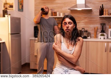 Traumatised Woman In Kitchen After Being Violent Bruised By Agressive Husband. Man Abusing Injuring 
