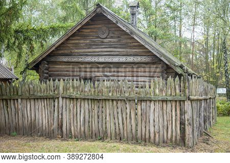 Ancient Style Wooden Wall Palisade. High Wooden Antique Palisade. Fence Made Of Sharp Wooden Stakes 