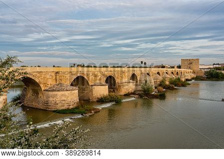 Cordoba, Spain - October 30, 2019: Roman Bridge, Across Guadalquivir River With Torre De Calahorra, 