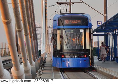 Modern City Blue Tram Lajkonik On The City Crakow Street. Eco-friendly Urban Public Transport. Urban