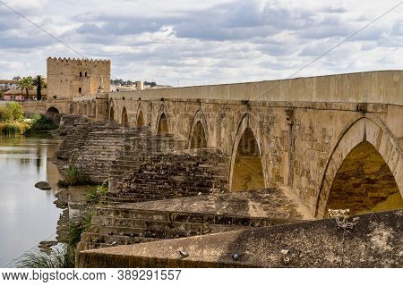 Cordoba, Spain - October 31, 2019: Roman Bridge, Across Guadalquivir River With Torre De Calahorra, 