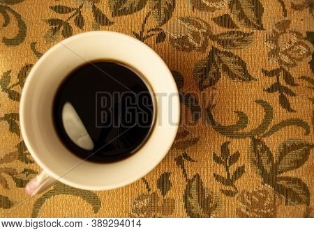White Cup With Black Coffee On The Yellow Table.