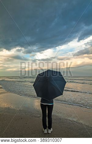 A Woman Looking At The Stormy Sea