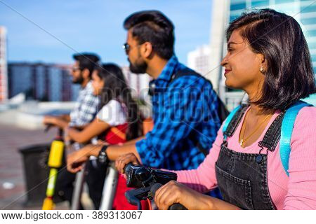 Modern Indian Friends Ride On Segway In Park In India