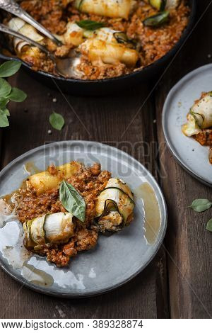 Baked Zucchini Rolls With Ricotta Cheese And Herbs In Meat Ragu Bolognese And Basil