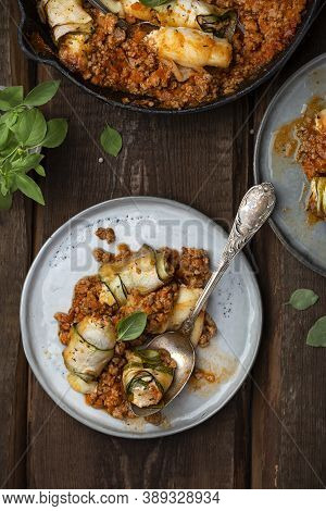 Baked Zucchini Rolls With Ricotta Cheese And Herbs In Meat Ragu Bolognese And Basil