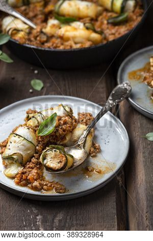 Baked Zucchini Rolls With Ricotta Cheese And Herbs In Meat Ragu Bolognese And Basil