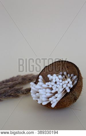 Wooden Ear Sticks In A Coconut Cup. Zero Waste Concept