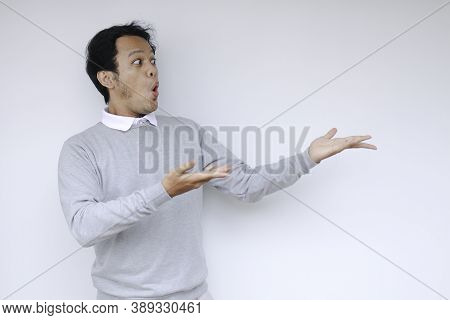 Young Asian Man Waer White Shirt Is Surprised And Shouting Wow With Pointing Right With His Finger I