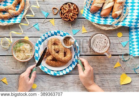 Oktoberfest Traditional Food And Beer. Top View On Wood With Blue White Decorations, Eating Alone