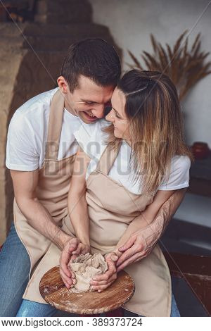 Romantic Couple In Love Working Together On Potter Wheel And Sculpting Clay Pot Man And A Young Woma