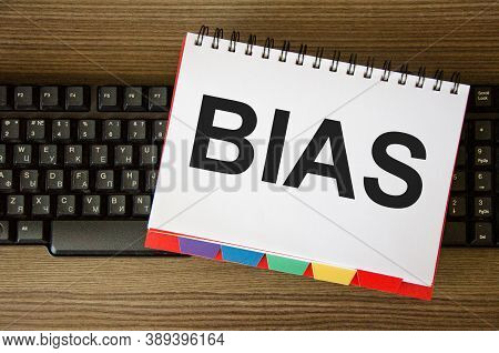 The Word Bias Is Written On A White Piece Of Paper That Is On The Keyboard. The Concept Of Bias Bias