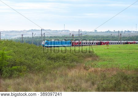 Anapa, Russia - 09.26.2020: A Russian Railways Train Moves On Rails Among Fields And Meadows