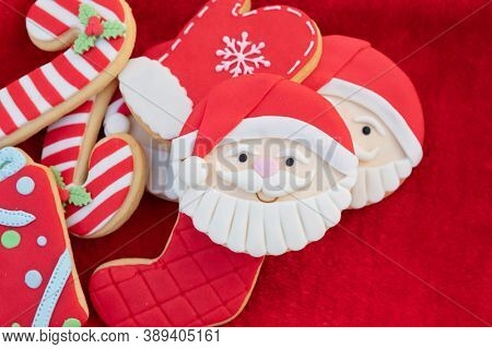 Christmas Cookies With Santa Face On Red Fur Background 