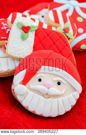 Christmas Cookies With Santa Face On Red Fur Background 