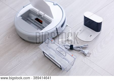 Robotic Vacuum Cleaner. Container With Garbage From A Smart Robot Vacuum Cleaner. Housework And Tech