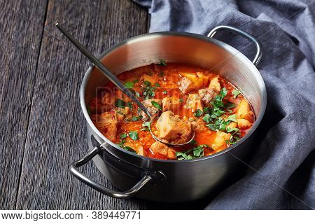Chicken Arrabbiata Stew With Lentil And Potato In A Pot On A Wooden Table, Horizontal View From Abov