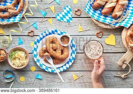 Oktoberfest, Celebrating Alone. Traditional Food And Beer, Top View On Wooden Table,