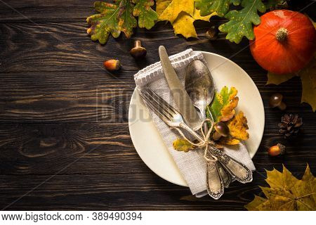 Autumn Table Setting With Craft Plate, Silverware And Fall Decorations. Dark Wooden Table, Toned Ima