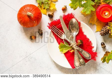 Thanksgiving Food Concept. Autumn Table Setting With Craft Plate, Silverware And Fall Decorations At