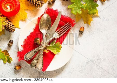 Thanksgiving Food Concept. Autumn Table Setting With Craft Plate, Silverware And Fall Decorations At
