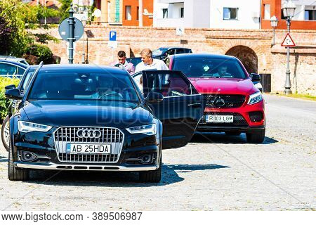 Modern Cars Parked On A Street. Black Audi A6 And Red Mercedes Benz Glc Class In Alba Iulia, 2020
