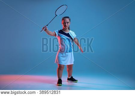 Action. Beautiful Dwarf Woman Practicing In Badminton Isolated On Blue Background In Neon Light. Lif