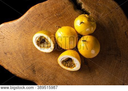 Passion Fruit On Rustic Wood, Black Background, Top View.