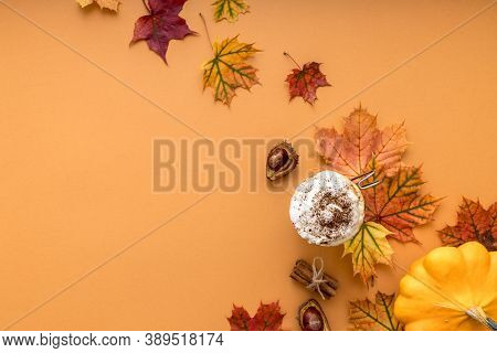 Cozy Autumn Style Flat Lay Of Hot Pumpkin Latte With Whipped Milk Cream, Cinamon And Colorful Dry Le